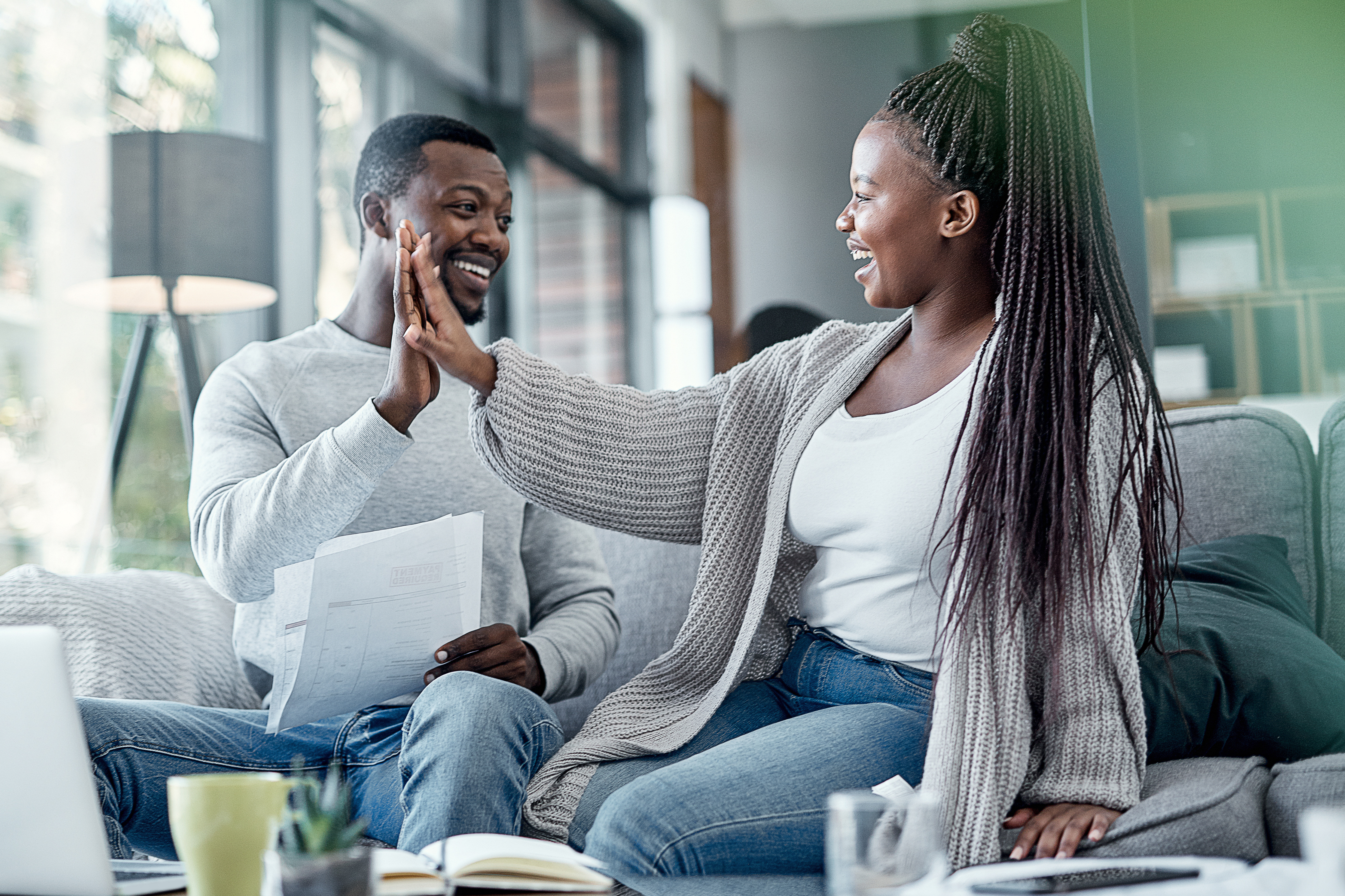 Couple celebrating their credit score improvement after getting a Credit Builder Loan.