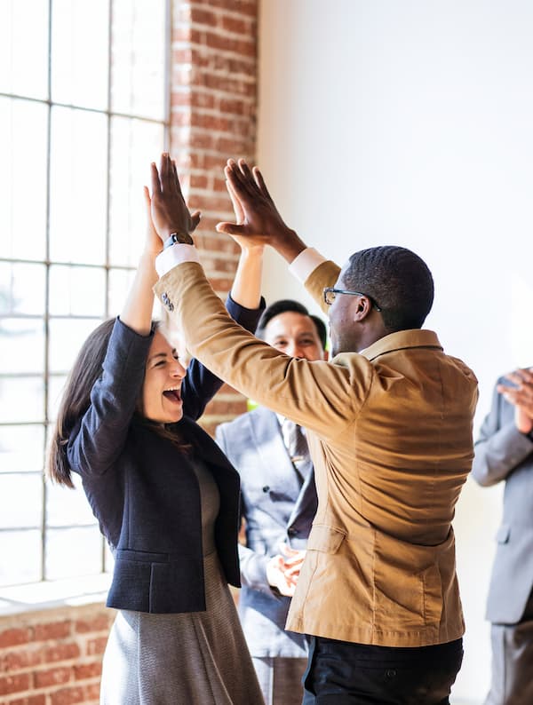 Happy employees celebrating new financial benefits through Telcoe Federal Credit Union membership.